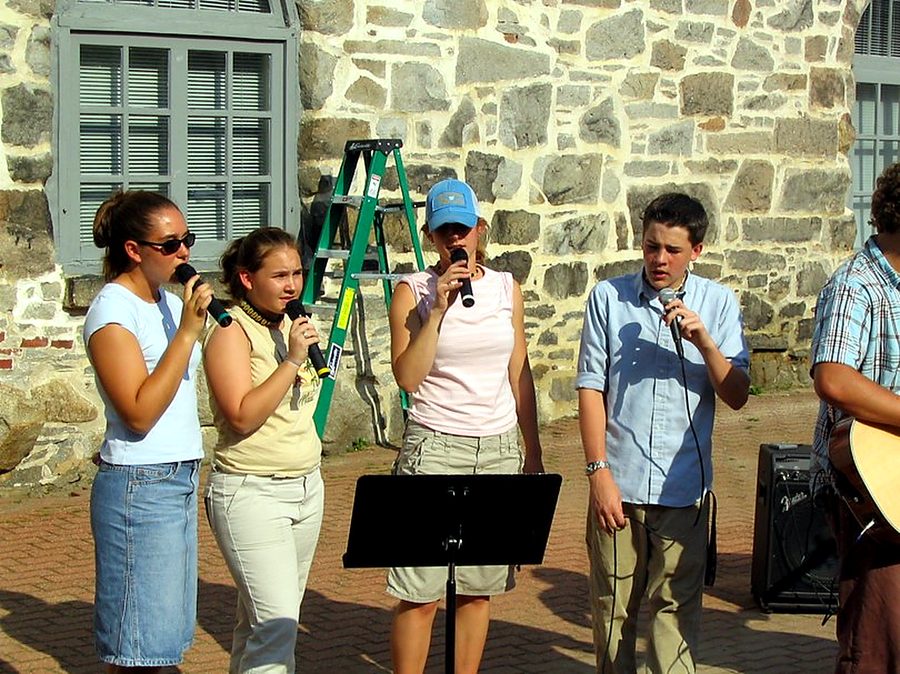 Team singing with students